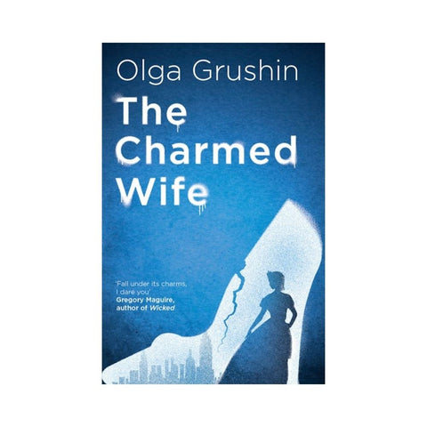 Book cover of 'The Charmed Wife' by Olga Grushin with a silhouette of a woman and cityscape.